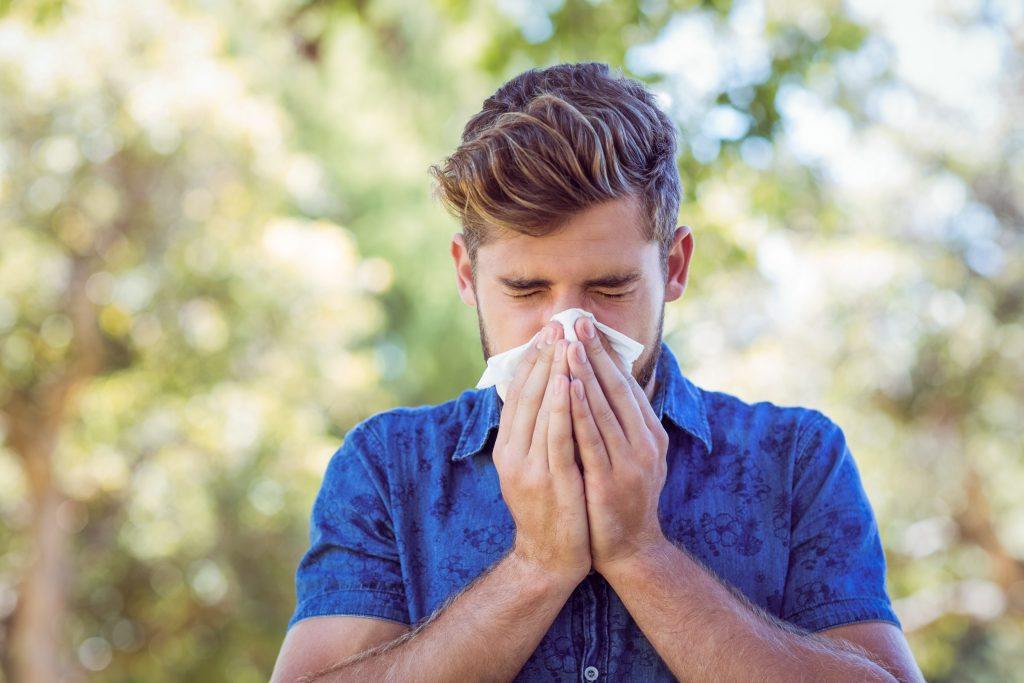 handsome hipster blowing his nose on a sunny day PC3GCMG 1024x683 1 - best essential oil brands