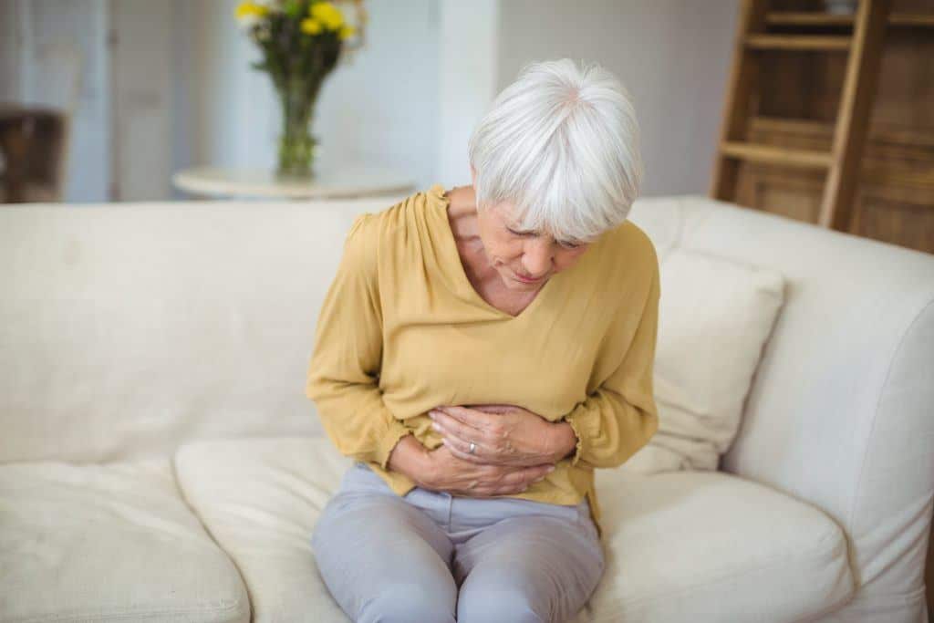 senior woman suffering from stomach pain in 8VT2BWC 1024x683 1 - best essential oil brands